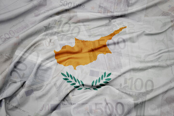 waving colorful national flag of cyprus on a euro money banknotes background. finance concept.