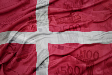 waving colorful national flag of denmark on a euro money banknotes background. finance concept.