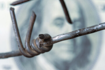 Economic confrontation and warfare, sanctions and embargo busting concept. Close up barbed wire...
