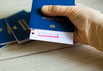 Passport and note with Covid-19 inscription.