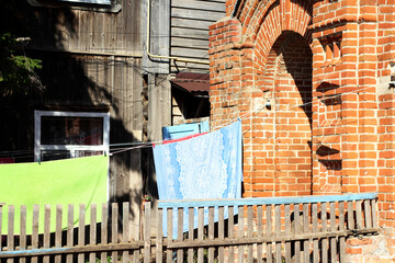 drying towels on a sunny summer afternoon in the courtyard of a wooden house  