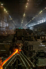 Iron and steel industry in a metallurgical plant at night.