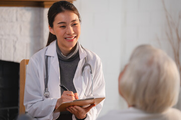 Senior Woman Receives Medical Advice and Treatment from a Doctor in a Hospital: Health Care Professionals Provide Help and Care to Elderly Patients with Insurance in a Clinical Setting