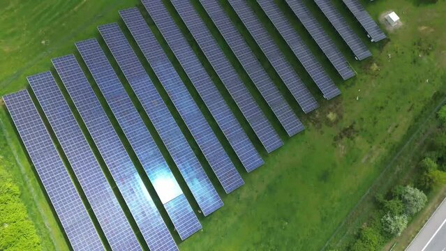 Drone flight on a German highway with lots of traffic and large solar panels next to the road.