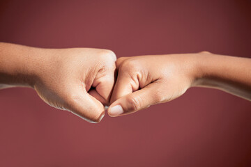 Fist bump, people and teamwork in studio for agreement, collaboration or deal by red background....
