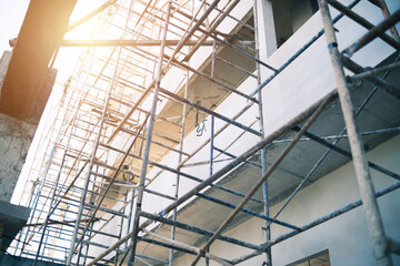 Construction building site with framework railing guard walkway on the building for workers to...