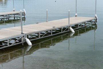 floating dock on calm waters at the lake - Powered by Adobe