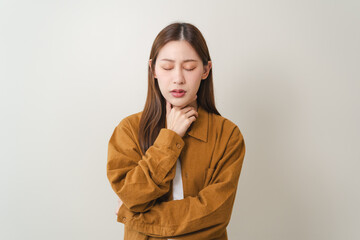 Woman touching at her neck and feeling hurt in her throat from influenza virus.