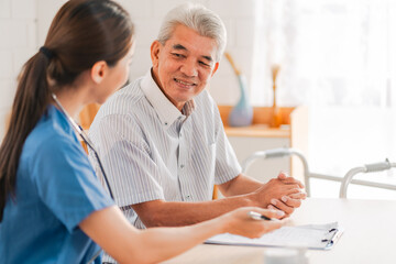 Senior Man Receives Medical Check-Up Therapy from Doctor in Hospital Clinic: Professional Health Care Service for Elderly Patients Facing Health Problems, with Comprehensive Exams and Consultations