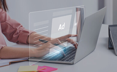 Digital marketing concept with businesswoman using computer laptop creating online adverts to...