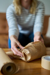 Woman Wrapping Parcel Protected With Green Environmentally Friendly Paper Or Plastic Free Honeycomb...