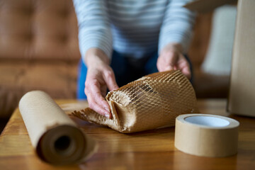 Woman Wrapping Parcel Protected With Green Environmentally Friendly Paper Or Plastic Free Honeycomb...