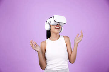 Smart female standing with pink background wearing VR headset connecting metaverse, futuristic...