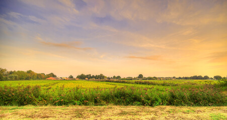 Evening falls over the sleepy village of Aarle-Rixtel, The Netherlands. A rural landscape from afar.