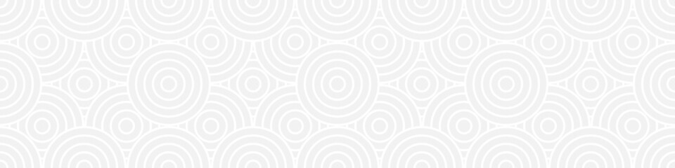 Seamless trend ornament of circles and arcs, geometric white shapes for textiles and wallpaper. Abstract panoramic pattern on a gray background for a New Year or wedding cover or card.