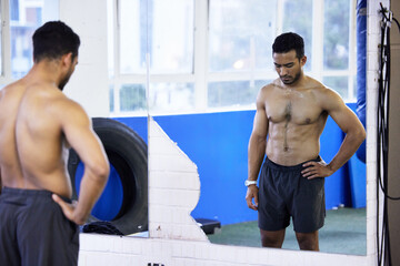 Mirror, muscle and body of man in gym to check fitness, wellness and results of healthy exercise on stomach. Abs, reflection and strong shirtless person sweating, bodybuilder or abdomen in sport club