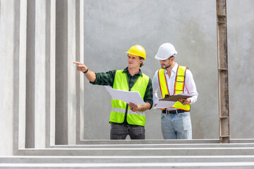 Engineer and foreman worker checking project at precast factory site, Engineer and builders in...