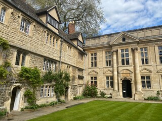 Historic English manor house featuring limestone architecture, dormer windows, and classical...