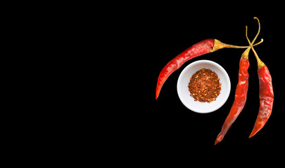 Chili  peppers   in bowl on a back  background.