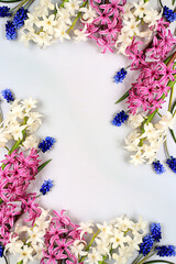Beautiful spring flowers hyacinths and muscari on a light background, flyer.Abstract floral composition, still life with space for text, floral holiday card, summer greeting concept, selective focus