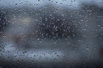 Rain drops on window glass closeup macro. Blue Abstract background texture with rain drop