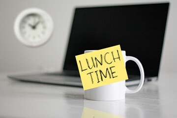 Lunch time in the office is shown using the text on the cup and photo of clock. Time for a break
