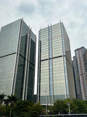 Obraz premium Bottom view of modern skyscrapers in business district against blue sky