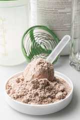 Whey protein powder in measuring scoop