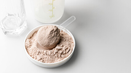 Whey protein powder in measuring scoop