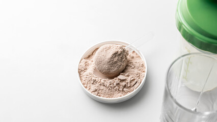 Whey protein powder in measuring scoop