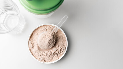 Whey protein powder in measuring scoop, top view