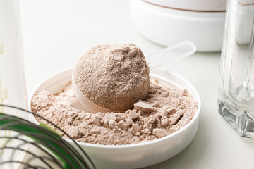 Whey protein powder in measuring scoop