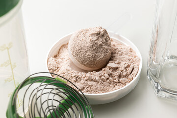 Whey protein powder in measuring scoop