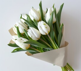 White tulips in paper wrap. - obrazy, fototapety, plakaty