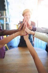 Teamwork, high five and business people on table in office for collaboration, community and...