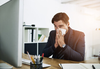 Sick, sneeze and business man in office with allergies, blowing nose and virus working at desk....