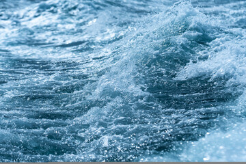 A Close up of Wave moving or splashing on water or ocean's surface, abstract wave background or...