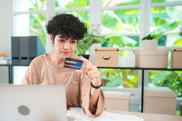 Happy Woman Working from Home Manages Finances and Makes Electronic Payments: Engaging in Online Shopping and E-Business Using Laptop for Banking, Credit Card Purchases, and Freelance Pay