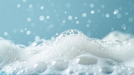 Lush white foam on a blue background, the structure of soap bubbles. Abstract background.