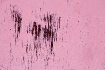 Rusty pink metal abstract background. Texture of an old plate with dripping stained cracked paint