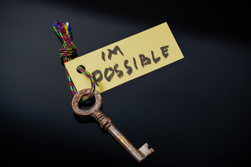 Key with I'M POSSIBLE written on paper