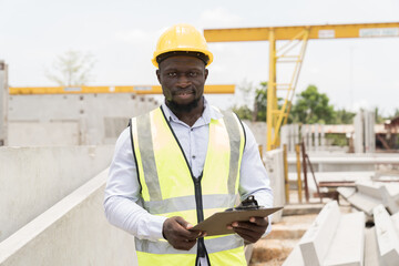 American African construction worker working at construction site. Foreman builder working at...