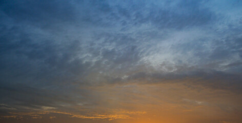 Blue sky with cirrus clouds and sunrise. Wide photo.