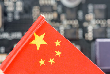 Flag of China fly over a motherboard containing a processor, CPU microchip. A semiconductor war...