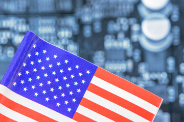 Flag of the US fly over a motherboard containing a processor, CPU microchip. A semiconductor war...