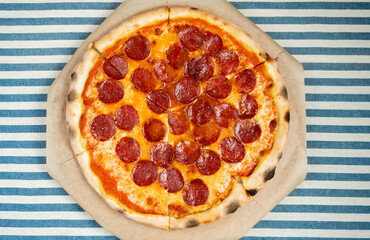 Traditional Italian pizza lying on the table, flat lay, top view