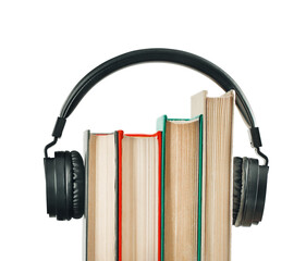 collection of vintage hardback books are combined with headphones. technology, education concept
