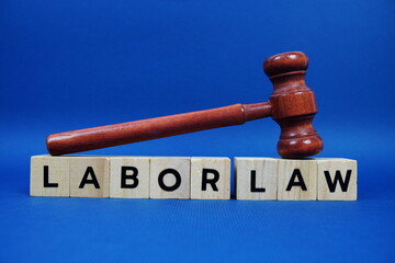 Labor Law alphabet letters with wooden blocks alphabet letters and Gavel on blue background