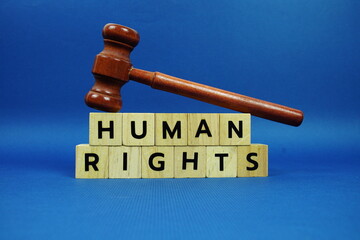 Human Rights alphabet letters with wooden blocks alphabet letters and Gavel on blue background
