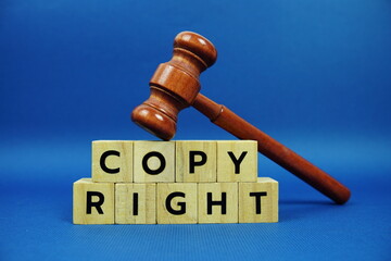 Copy Right alphabet letters with wooden blocks alphabet letters and Gavel on blue background